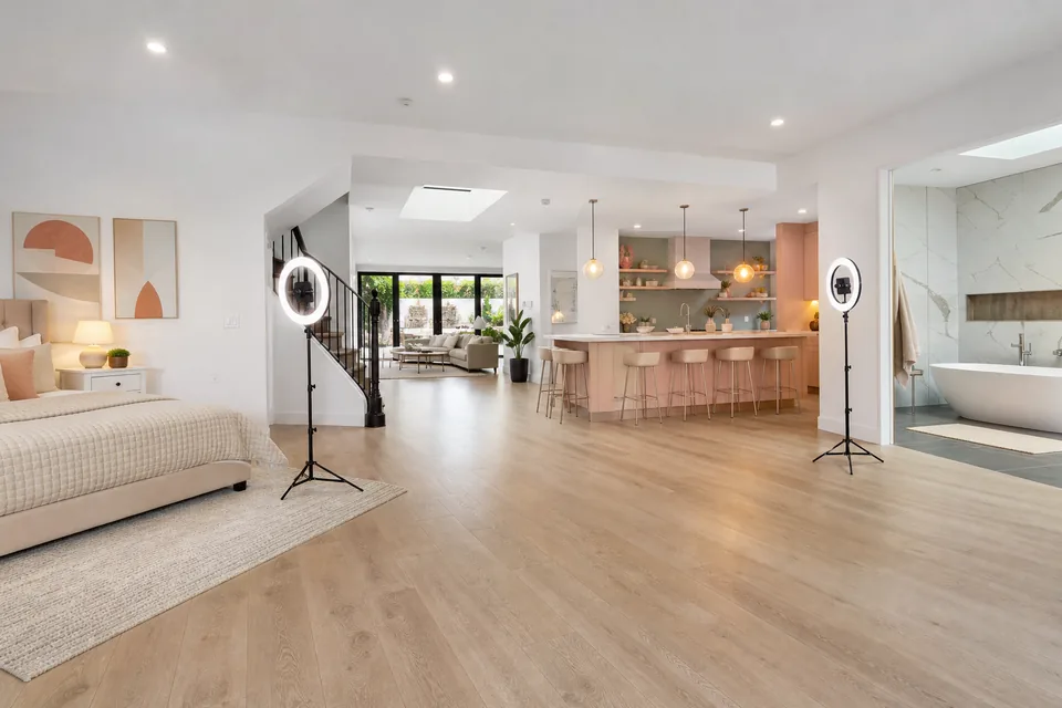 Open plan content creator house with styled bedroom, kitchen and bathroom sets and ring lights